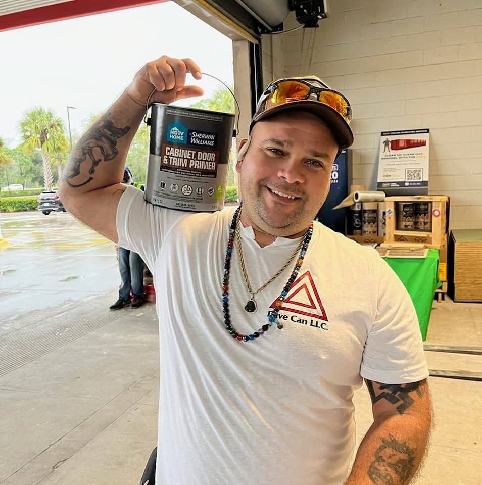 Dave, owner of Dave Can LLC, holding painting supplies